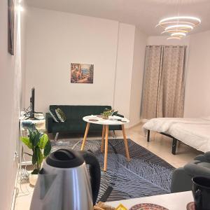 a living room with a couch and a table at PHANTOM ,Buisness Master Suite Private Toilet , Horizon,AJMAN in Ajman 