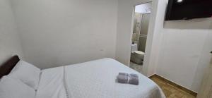 a bedroom with a bed with two towels on it at Alojamiento Sol Naciente in Puerto Triunfo +21 photos