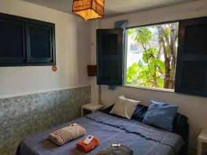 a bedroom with a bed with two pillows on it at Pousada A Vida é Bela in Águas Belas