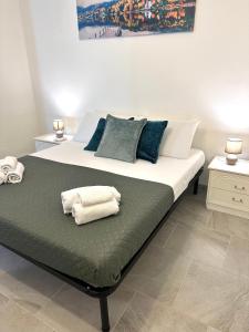 a bedroom with a bed with towels on it at Garden House in Olbia