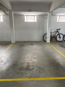 a garage with two bikes parked in it at Fique a 2min da Igreja Canela in Canela
