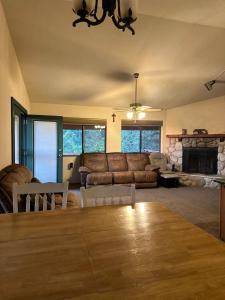 a living room with a couch and a table at Charming Pine Mountain Home with Family Space in Frazier Park +7 photos