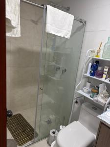 a shower with a glass door in a bathroom at Casa campestre VALLE ESCONDIDO in Cómbita