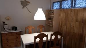 a dining room with a white table and chairs at Birkikinn Holiday Home in Birkikinn