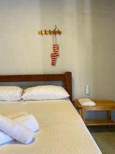 a bedroom with a bed with a chili pepper on the wall at Céu - Quarto com entrada privada in Luis Correia