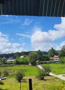 a view of a green field with a blue sky at Campsite on a terrace within 1km of Ziro Music Festival in Ziro
