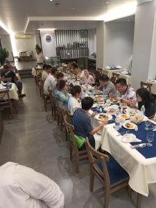 a group of people sitting at tables eating food at Pyramids Oasis Hotel - Giza in Cairo