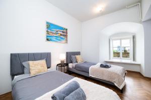 a bedroom with two beds and a couch at Luxury Villa style, best view, terrace, BBQ, 2BR, 2-bath in Tallinn