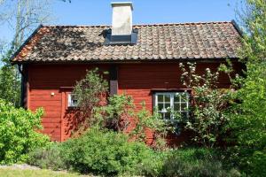 a red house with a chimney on top of it at KAL687-Kristdala-Stora-Brabo-1 in Bråbo