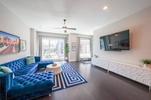 a living room with a blue couch and a tv at Spectacular Vista in Atlanta