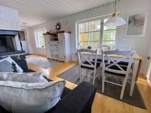 a living room with a table and chairs and a kitchen at GAV757-Norrala-Kungsgardssjoearna-287 in Norrala