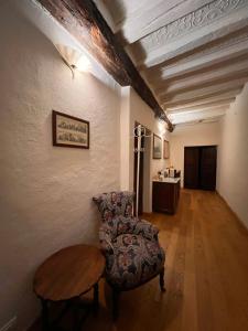 a living room with a chair and a table at Casa Rossa - Sweet Harmony in Castellinaldo