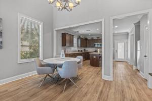 a kitchen and dining room with a table and chairs at Luxury 2 bedroom Townhouse #5 in Prien