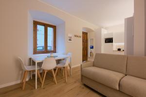 a living room with a couch and a table and chairs at Lynx Retreat 1BR Apartment B in Tarvisio +16 photos
