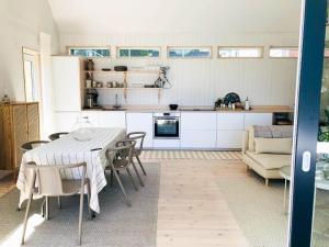 a kitchen and dining room with a table and chairs at BLE693-Soelvesborg-Hasselvaegen-9 in Hällevik