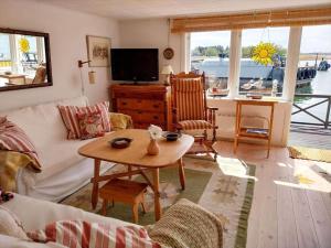 a living room with a couch and a table at STO717-Blidoe-Nedre-Byvaegen-56 in Blidö