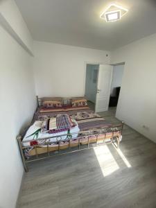 a bedroom with a bed in a white room at Ploiesti-Republicii RH in Ploieşti