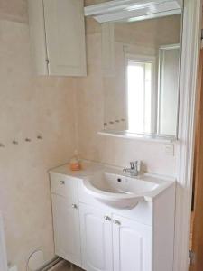 a bathroom with a white sink and a mirror at VGO715-Hova-Hulan-Strandvaegen-9 in Vallsjöbol