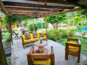 a patio with a couch and chairs and a table at Hotel Urumajó in Augusto Correa