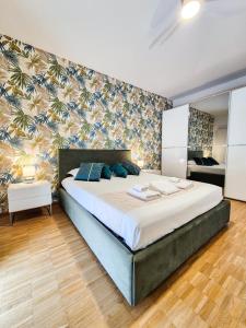 a bedroom with a large bed with blue pillows at Romantic Lake View Apartment with Balcony and Parking in Orselina Locarno in Orselina