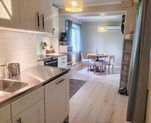 a kitchen with a table and a dining room at SOD691-Stavsjoe-Kila-Skogsby-Nygarden-3 in Stavsjo +6 photos