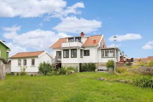 una gran casa blanca con un patio verde en BOH651-Kaeringoen-Kosen-560, en Käringön