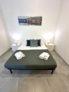a bedroom with a bed with two towels on it at Garden House in Olbia +17 photos