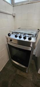 a stove top oven sitting in a kitchen at SCR - Botafogo - Aconchegante 2 Quartos a 50 Mt do Metrô in Rio de Janeiro +36 photos
