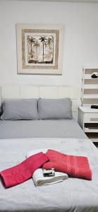 a red towel is laying on a bed at SCR - Botafogo - Aconchegante 2 Quartos a 50 Mt do Metrô in Rio de Janeiro
