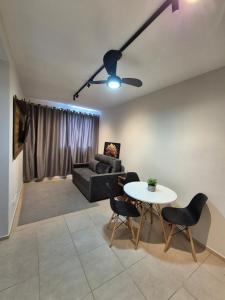 a living room with a couch and a table at Apartamento de 1 quarto !! in Joinville