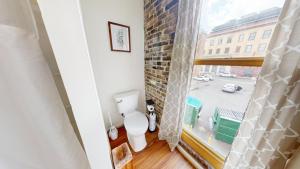a bathroom with a toilet and a window at The Lofts at 107 in Nashville +41 photos