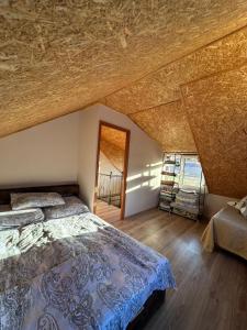 a bedroom with a bed and a wooden ceiling at The Familay Garden in Nurrnus