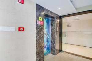a glass door in a wall with signs on it at Palette Sapphire Star Chappan Market in Indore +29 photos