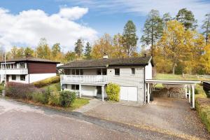 a white house with a porch and a garage at KAL535-Virserum-Askliden-11 in Virserum