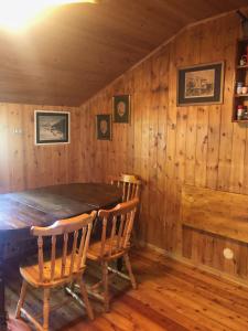 a dining room with a wooden table and chairs at Chalet Alma in Champoluc