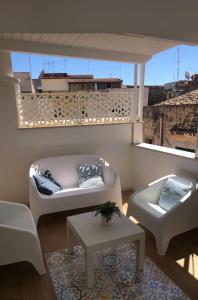 a living room with a couch and a table at Home holiday Kalanto in Castellammare del Golfo