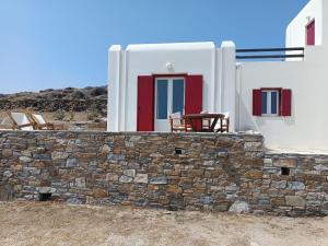 a stone wall in front of a house at Kythnos - Loutra- House in Loutra