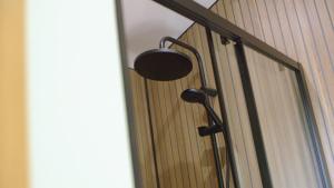a shower head on a wall with a window at Glen Wyllin Campsite in Kirkmichael