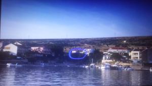 a blue object in the middle of a body of water at Apartments Antica in Šimuni