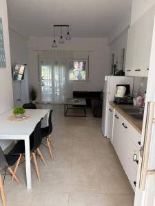a kitchen and living room with a table and a table and chairs at Maisonette Fanari in Fanárion +9 photos