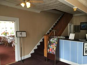 a room with a staircase leading to a kitchen at The Tunnicliff Inn in Cooperstown