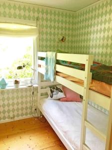 a bedroom with two bunk beds and a window at ORE739-Motala-Forsanaesvaegen-26 in Rå