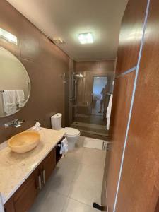 a bathroom with a sink and a toilet and a shower at Oceanview Punta Arrocito Luxury Condo, Near Arrocito Beach in Santa Maria Huatulco +32 photos