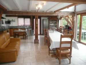 a kitchen and dining room with a table and chairs at Les gites de l'étang in Champdray