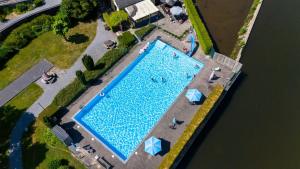 an overhead view of a large swimming pool with people around it at L'apais'Han in Rochefort
