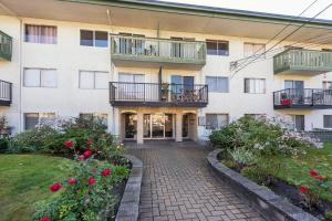 an apartment building with balconies and a courtyard at One Bedroom Suite in perfect location Vancouvers Mount Pleasant in Vancouver