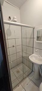 a bathroom with a shower and a sink at Pousada Mar de Itacaré in Itacaré