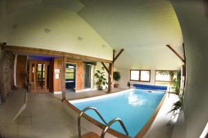 a large swimming pool in a house at Les gites de l'étang in Champdray
