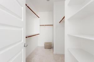 a hallway with white walls and a white closet at Modern Desert Home-Great for families & groups, near golf, hiking, and city fun in Phoenix +48 photos