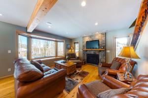 a living room with leather furniture and a fireplace at American Way Chalet in Breckenridge